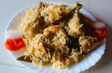 Chicken Yakhni Pulao Recipe in white plate